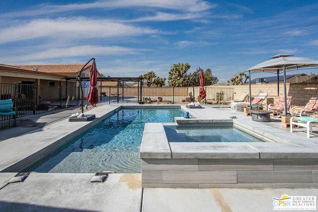 view of swimming pool with an in ground hot tub and a patio area