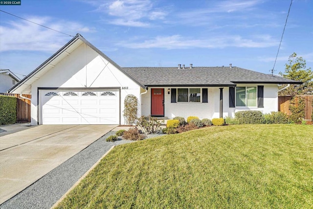 ranch-style home featuring a garage and a front lawn