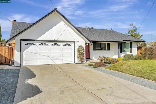 ranch-style house featuring a garage and a front yard