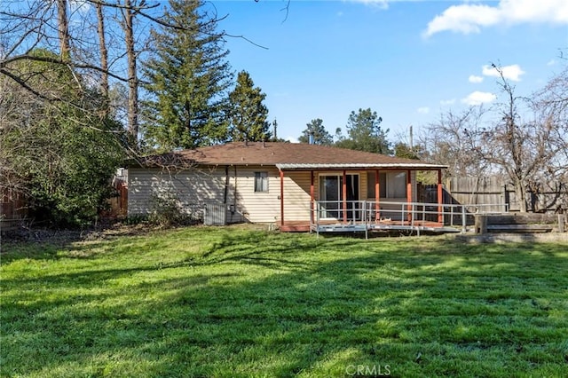 back of house featuring a lawn