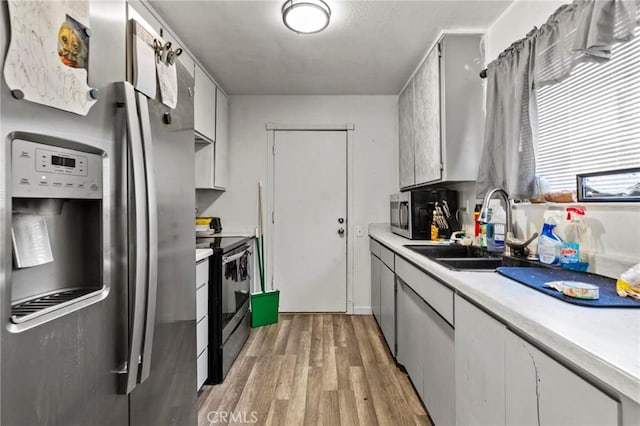 kitchen featuring sink, stainless steel appliances, and light wood-type flooring