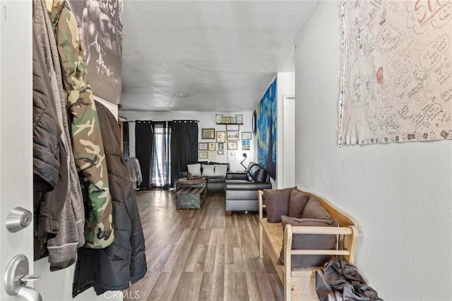 corridor featuring hardwood / wood-style flooring and a textured ceiling