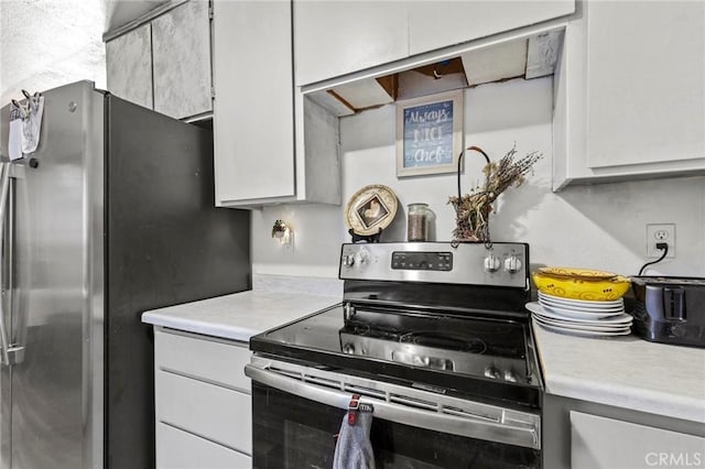 kitchen featuring stainless steel appliances and white cabinets