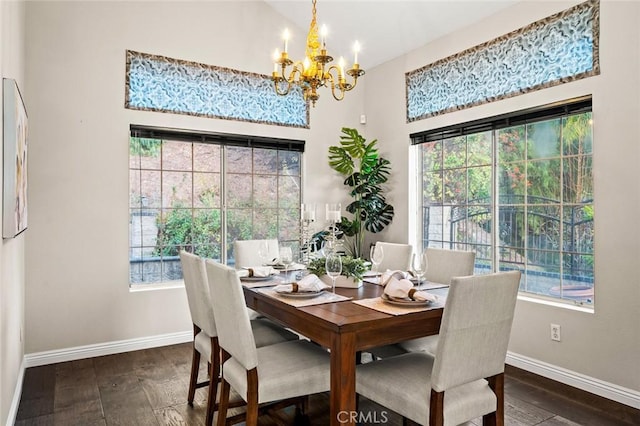 dining room with an inviting chandelier, plenty of natural light, and dark hardwood / wood-style floors