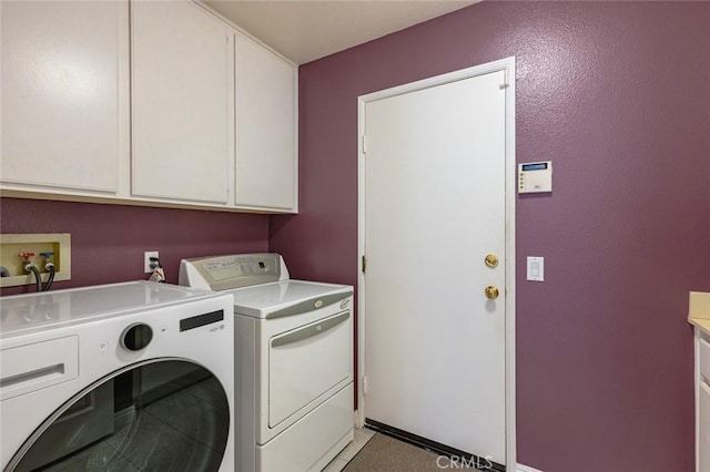 washroom with separate washer and dryer and cabinets