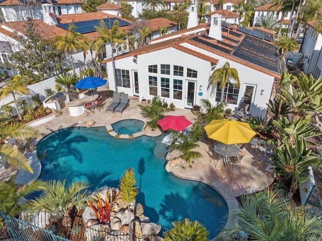 view of swimming pool featuring an in ground hot tub and a patio area