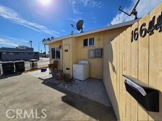 view of patio with electric panel and washer / dryer