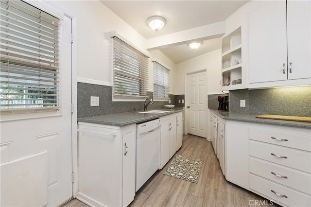 kitchen featuring white cabinetry, sink, white dishwasher, and a healthy amount of sunlight