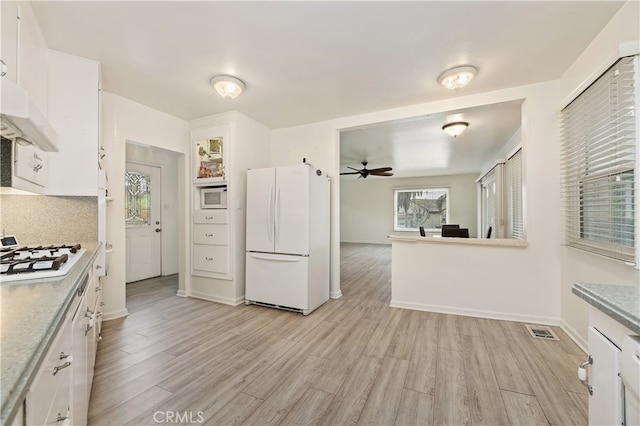 kitchen featuring white cabinetry, white appliances, and light wood-type flooring