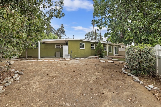 back of property with a carport