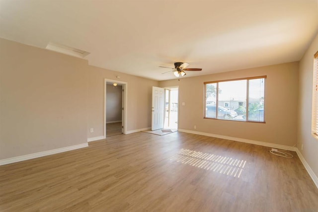 empty room with light hardwood / wood-style floors and ceiling fan