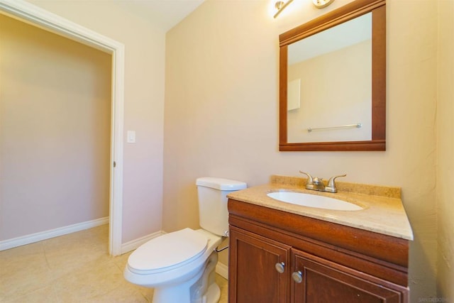 bathroom featuring vanity, tile patterned floors, and toilet