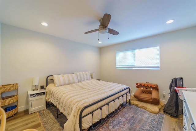 bedroom with light hardwood / wood-style floors and ceiling fan