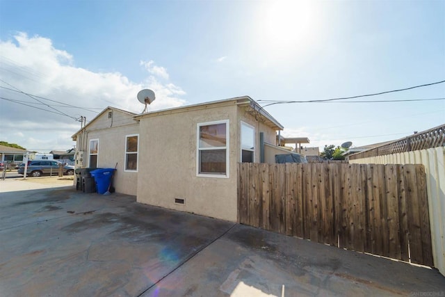 view of property exterior with a patio area