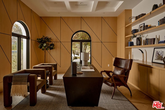 sitting room with built in shelves and coffered ceiling