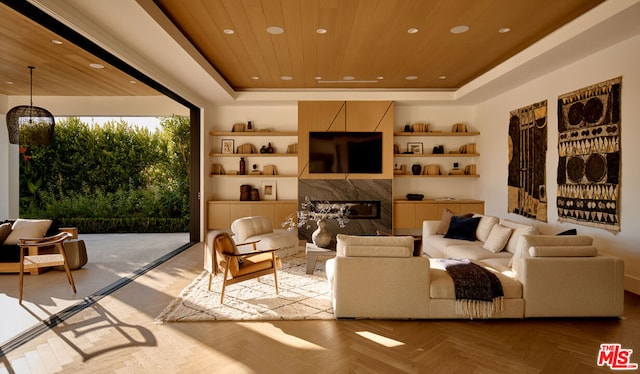 living room featuring a premium fireplace, wooden ceiling, a raised ceiling, and light parquet flooring