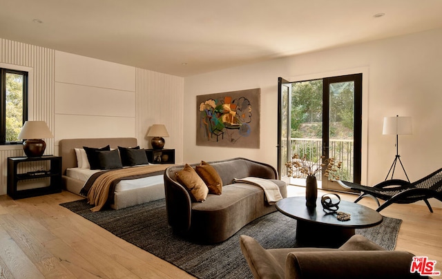 bedroom with access to outside and light wood-type flooring