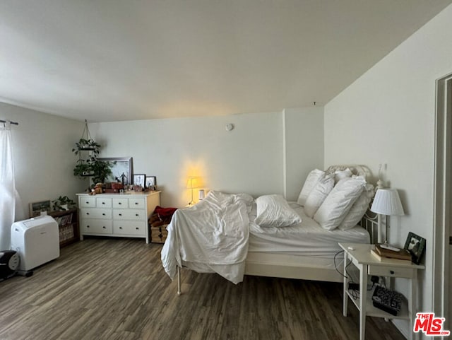 bedroom featuring dark hardwood / wood-style flooring