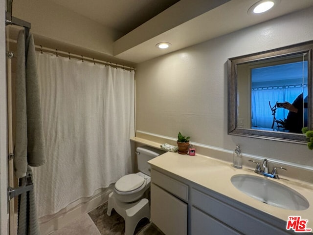 full bathroom featuring vanity, shower / bath combination with curtain, and toilet