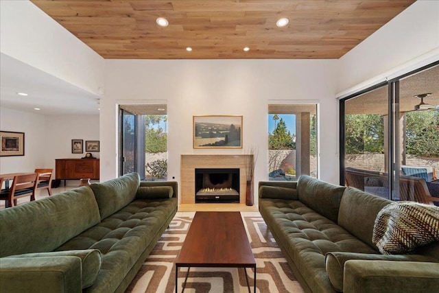 living room with wood ceiling, light hardwood / wood-style floors, and a healthy amount of sunlight