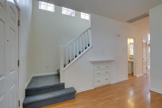 stairs with hardwood / wood-style floors