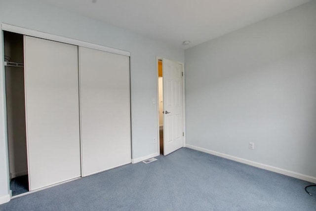 unfurnished bedroom featuring a closet and carpet