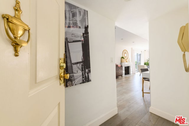 hallway with hardwood / wood-style floors