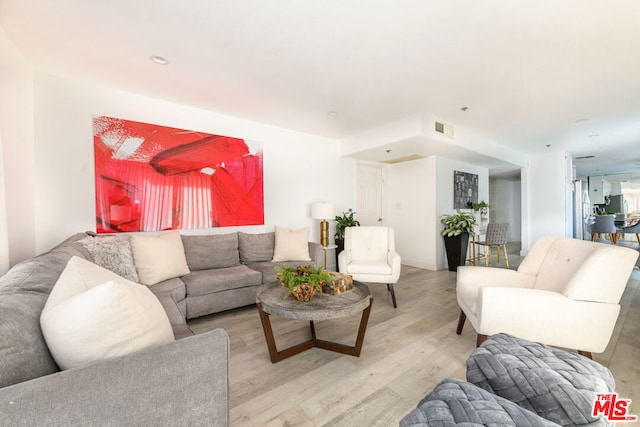 living room with light hardwood / wood-style flooring