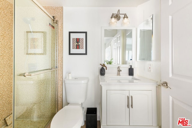 bathroom with walk in shower, vanity, and toilet