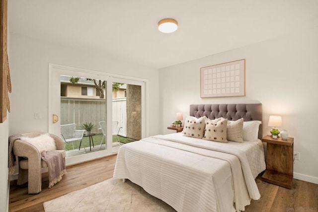 bedroom featuring access to outside and light hardwood / wood-style flooring