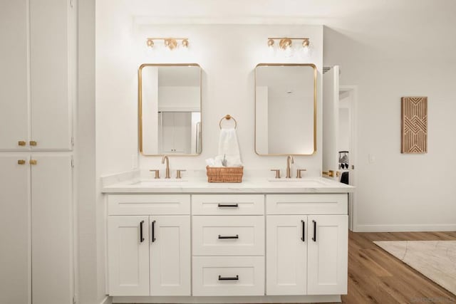 bathroom with hardwood / wood-style flooring and vanity