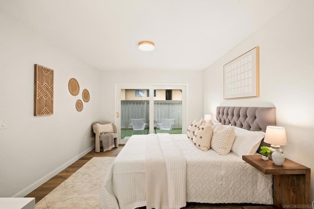 bedroom featuring hardwood / wood-style flooring and access to exterior