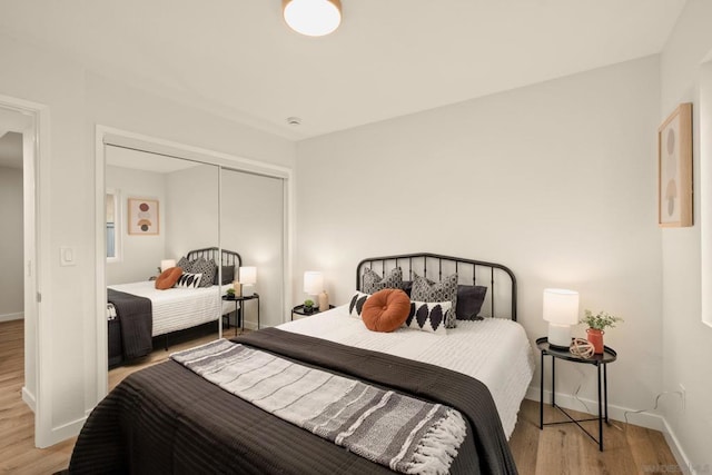 bedroom featuring light hardwood / wood-style floors and a closet