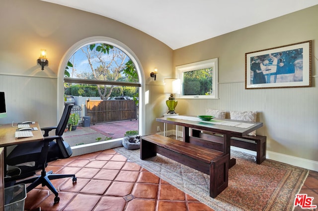 office space featuring vaulted ceiling and tile patterned floors