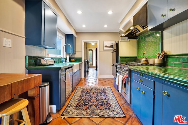 kitchen with washer / clothes dryer, blue cabinets, decorative backsplash, light tile patterned floors, and stainless steel appliances