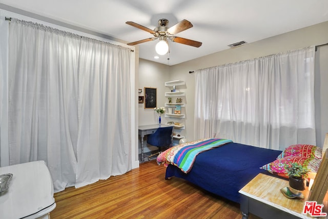 bedroom featuring hardwood / wood-style flooring and ceiling fan