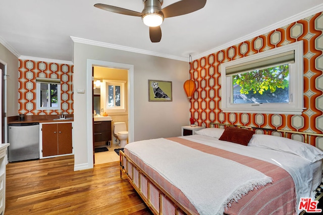 bedroom with connected bathroom, sink, crown molding, light wood-type flooring, and fridge