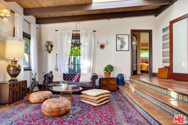 interior space featuring vaulted ceiling with beams, tile patterned floors, and wooden ceiling