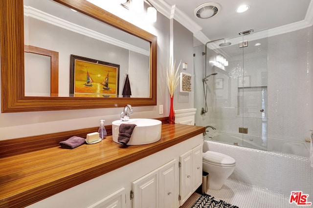 full bathroom with vanity, crown molding, bath / shower combo with glass door, and toilet