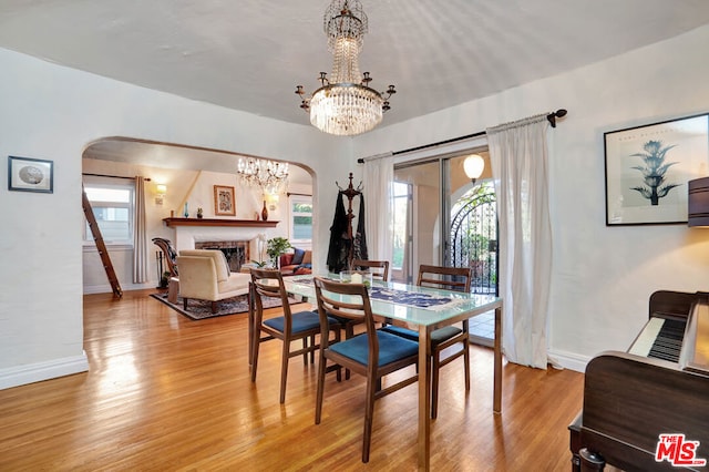 dining area with a notable chandelier and light wood-type flooring