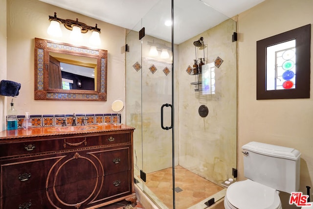 bathroom with vanity, an enclosed shower, and toilet