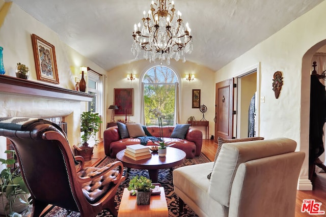 living room with vaulted ceiling and hardwood / wood-style floors