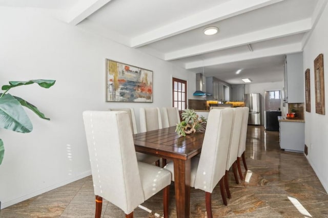 dining space featuring beam ceiling