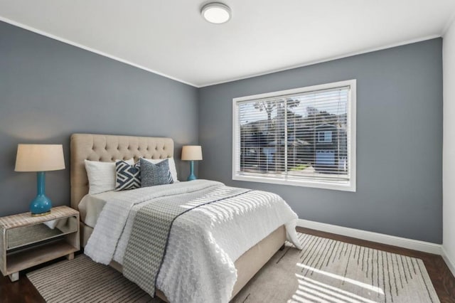 bedroom with wood-type flooring and crown molding