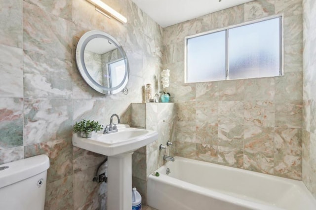 bathroom featuring toilet and tile walls