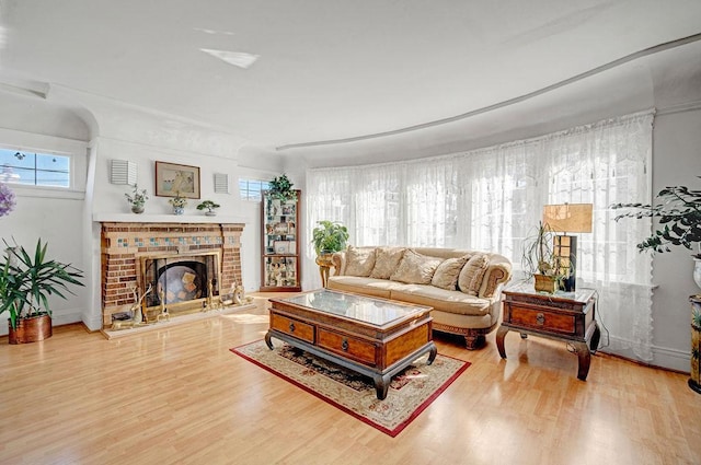 living room featuring a fireplace and light hardwood / wood-style flooring