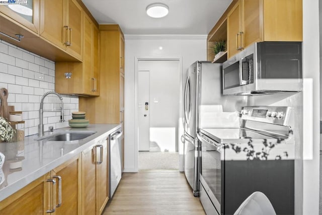 kitchen featuring sink, light hardwood / wood-style flooring, appliances with stainless steel finishes, backsplash, and ornamental molding