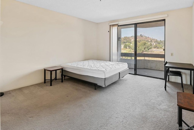 bedroom featuring access to outside and carpet