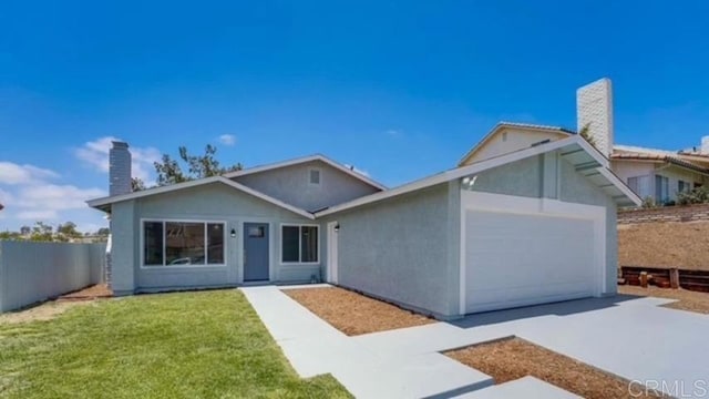 ranch-style house featuring a garage and a front yard