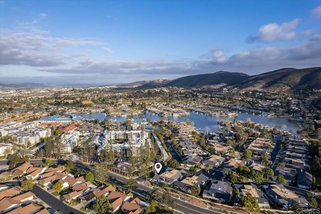 drone / aerial view featuring a water and mountain view